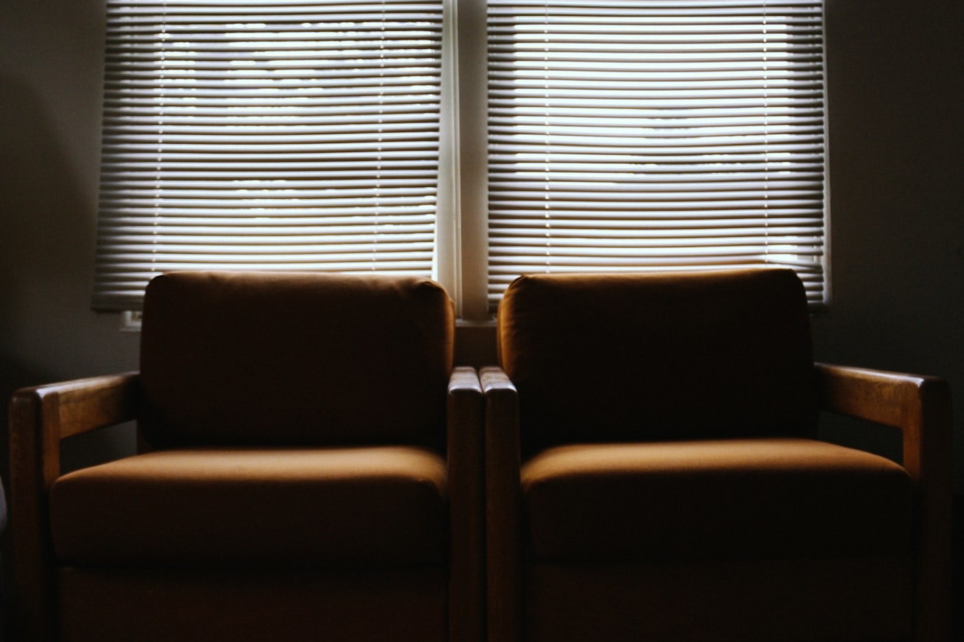 Two empty armchairs facing each other in a consulting room