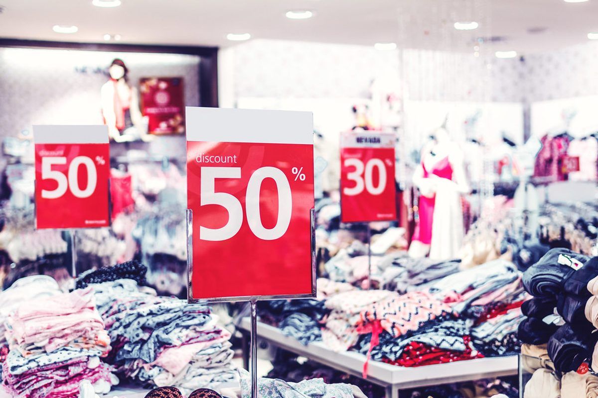 Discount and sale signage in a retail shop window